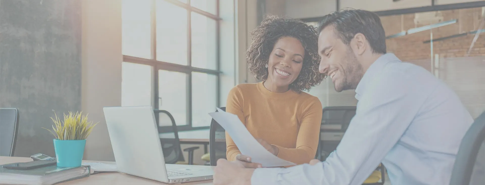 An agent reviewing a policy with a client